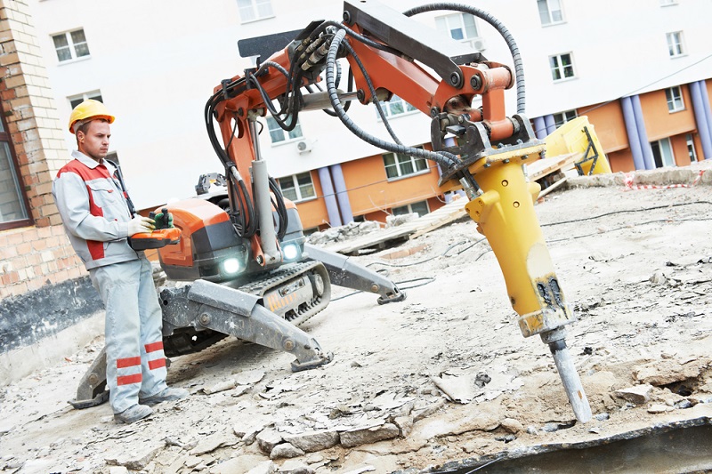 Professional demolition expert assessing a residential demolition site safely