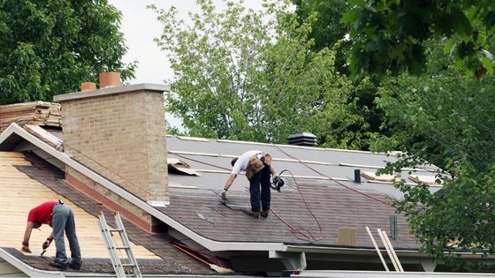 Professional roof restoration service repairing and repainting residential roof for long-lasting protection