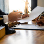Book cover of In Pursuit of Justice: Chronicles of a Criminal Lawyer showing a courtroom scene with a lawyer in focus