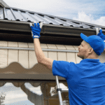 Professional technician installing seamless gutters on residential roof
