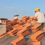 Professional roof restoration service repairing and repainting residential roof tiles